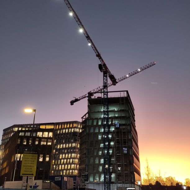 An office building complex under construction at dusk.