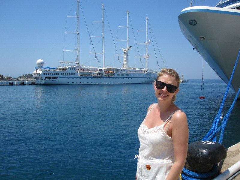 Anniken in front of a sail "boat" docked with the Navigator of the Seas in Kusadai harbor. Anniken in front of a sail "boat" docked with the Navigator of the Seas in Kusadai harbor.