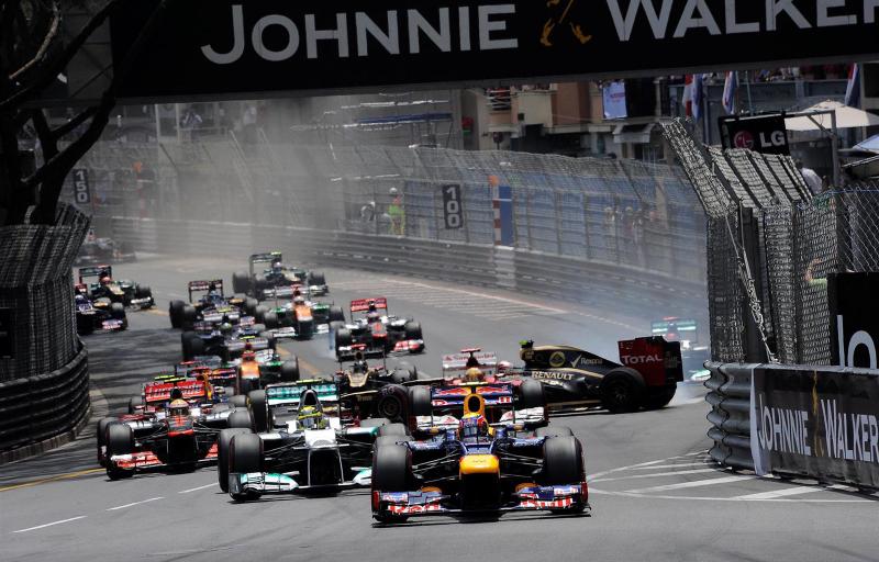 Mark Webber (AUS) Red Bull Racing RB8 leads as Romain Grosjean (FRA) Lotus E20 crashes out at the start of the race. Formula One World Championship, Rd6, Monaco Grand Prix, Race Day, Monte-Carlo, Monaco, Sunday, 27 May 2012. © Sutton Images. No reproduction without permission.