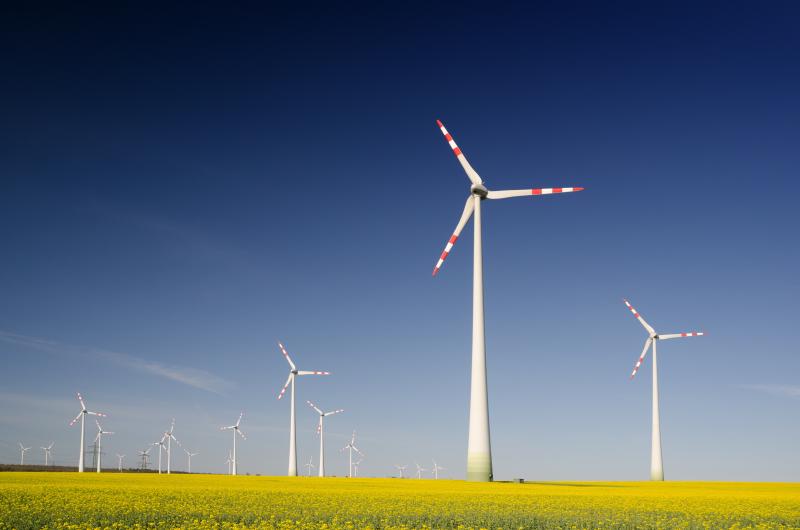 Windmills on grass field at daytime.