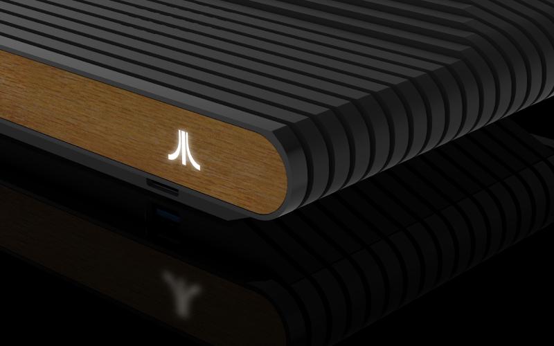 A computer generated image of the front of the Atari VCS with a white, glowing Atari logo.